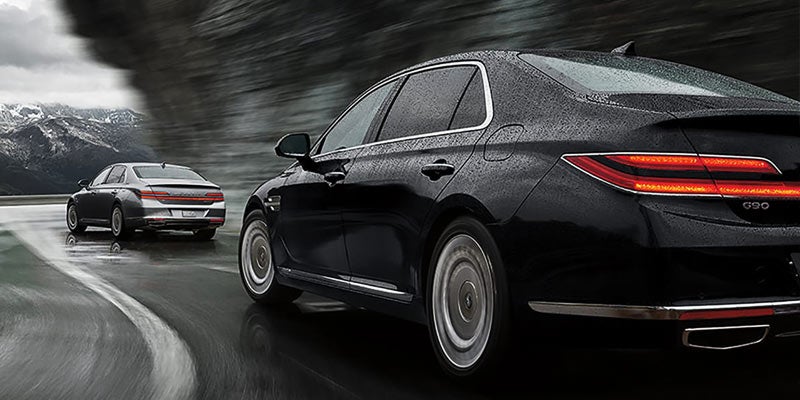 2021 Genesis G90 driving on road with another car